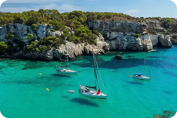 Curso PER Baleares y vela en Barcelona — Escuela Port, veleros fondeados en cala