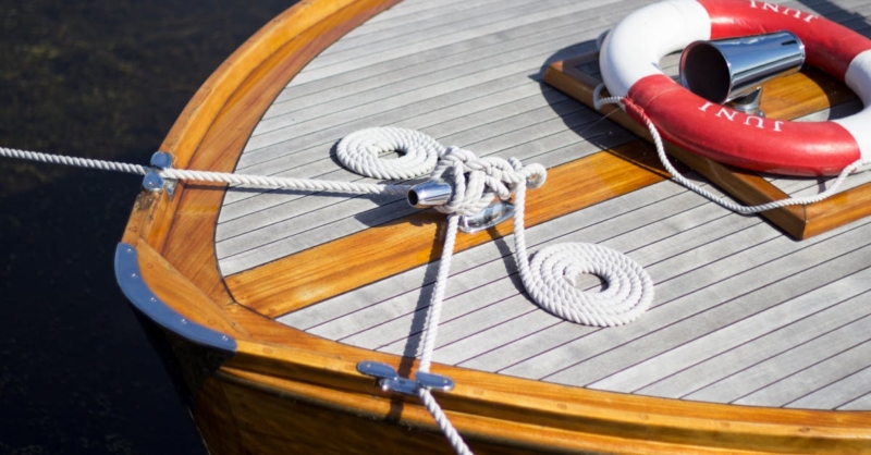 pexels-photo-997615-997615 A close-up of a wooden yacht deck featuring ropes and lifebuoy, ideal for nautical themes.